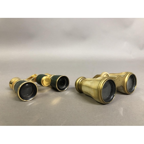 234 - Two pairs of opera glasses in cases, the first in gold metal with panels of cream mother of pearl, c... 