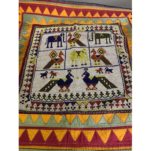 303 - Africa, woven, printed or beaded textiles: a large, colourful and heavy panel with machine patchwork... 