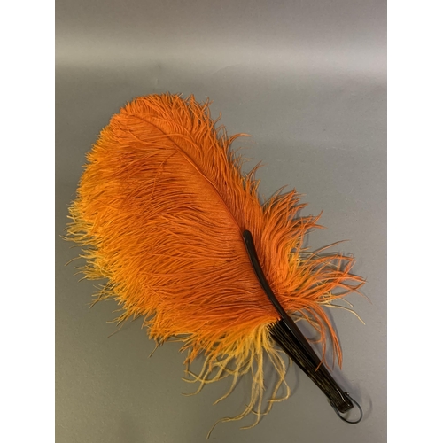 107 - A 1920’s shaded orange ostrich feather fan, light to dark left to right, the monture faux tortoisesh... 