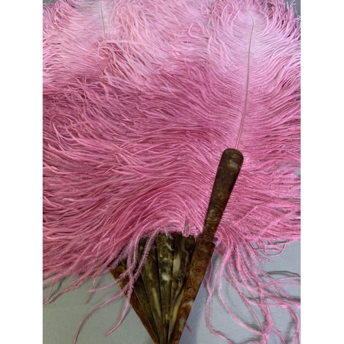 108 - A 1920’s shaded raspberry ostrich feather fan, the upper feathers sugar candy pink, the monture faux... 