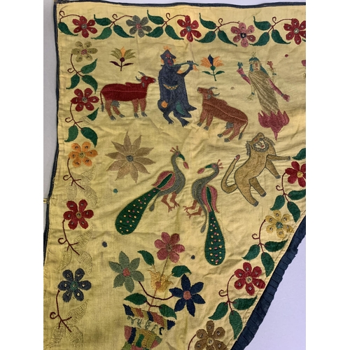 310 - A shaped linen door hanging, Toran, Indian, embroidered in coloured silks with flowers (some with si... 