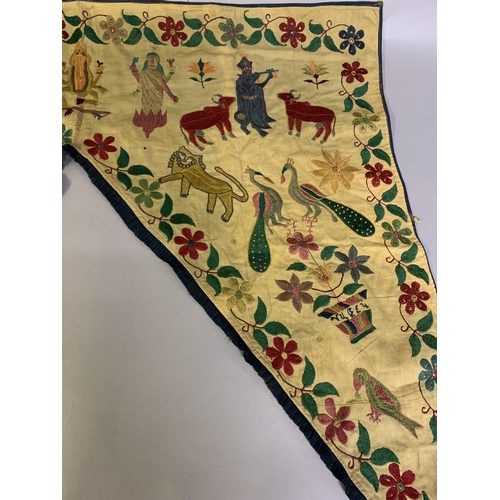 310 - A shaped linen door hanging, Toran, Indian, embroidered in coloured silks with flowers (some with si... 