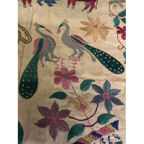 310 - A shaped linen door hanging, Toran, Indian, embroidered in coloured silks with flowers (some with si... 