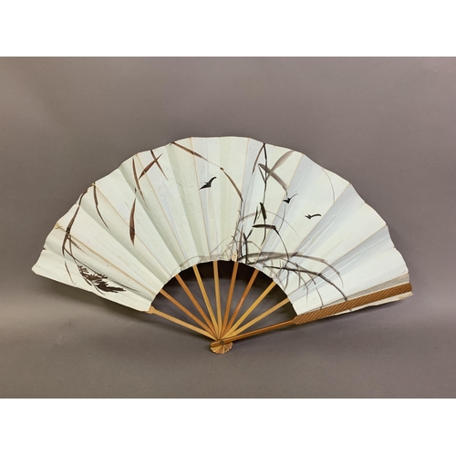 136 - Japanese fans: A dramatic gold and navy blue horizontal striped paper fan with double leaf, design r... 