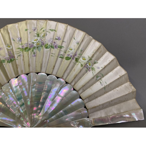 44 - Two mother of pearl fans, the first c 1910, the monture pink, the cream silk leaf backed with cream ... 