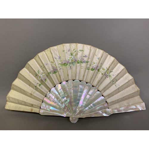 44 - Two mother of pearl fans, the first c 1910, the monture pink, the cream silk leaf backed with cream ... 