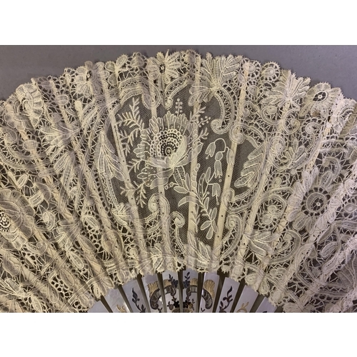 82 - A good Mixed Brussels lace fan, a central rose with raised petals and delicately worked harebells, t... 