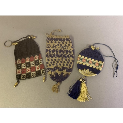 229 - Antique purses: Five small early 19th century beaded or crocheted purses, the first beaded in dark b... 