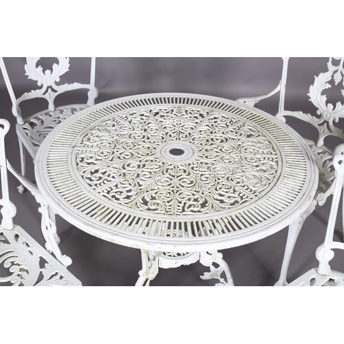 A white metal garden table and four chairs including two single chairs and two open armchairs, the t