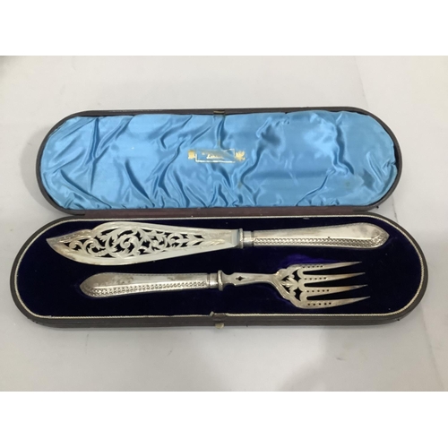 344 - A pair of Victorian silver fish servers, the silver blades pierced and engraved with foliate scrolls... 