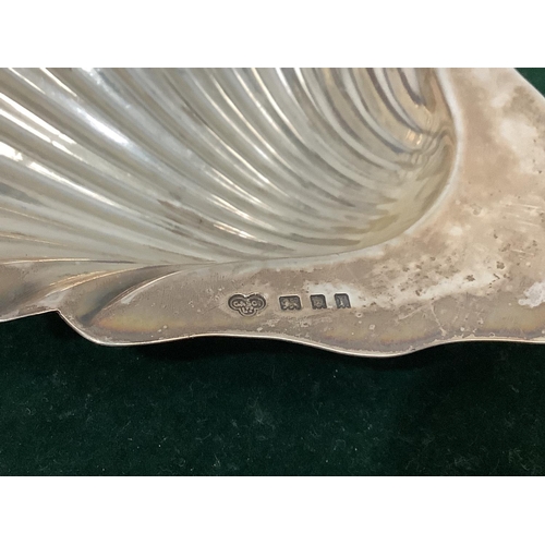 348 - A boxed pair of George V silver butter dishes by Goldsmiths & Silversmiths, each of scallop form on ... 