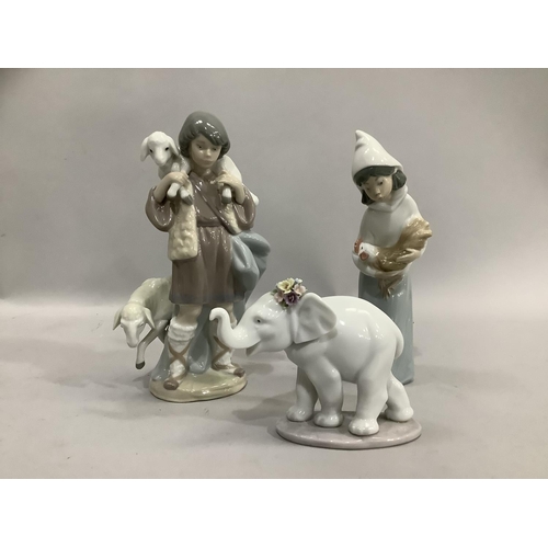 18 - Lladro figure of a shepherd with ewe and lamb 21cm high, a girl with cockerel 19.5cm and an elephant... 