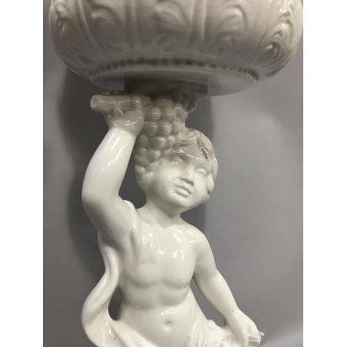 114 - Capodimonte style white jardiniere modelled as a cherub holding bunches of grapes supporting a bowl ... 