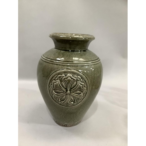 281 - Green mottled glazed vase with opposing moulded bosses, 28cm high