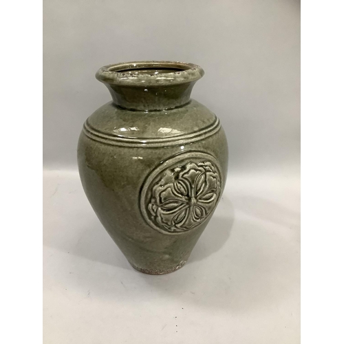 281 - Green mottled glazed vase with opposing moulded bosses, 28cm high