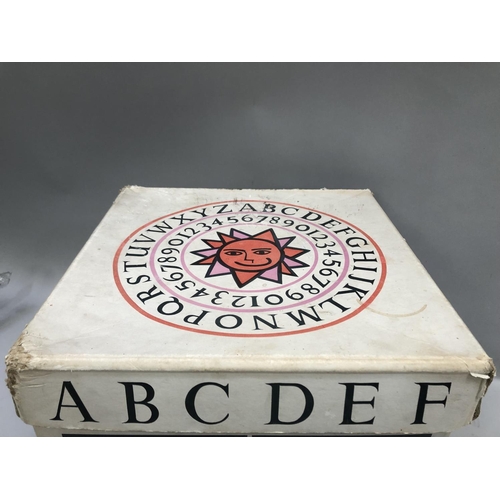 152B - A vintage toy box in white cardboard with alphabet and play toys in orange, pink and black