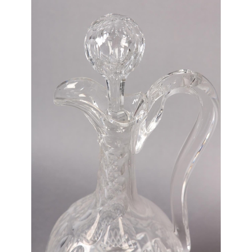 70 - A VICTORIAN CUT WINE EWER, having a faceted neck above cut oval panels, a band of etched grapevine a... 