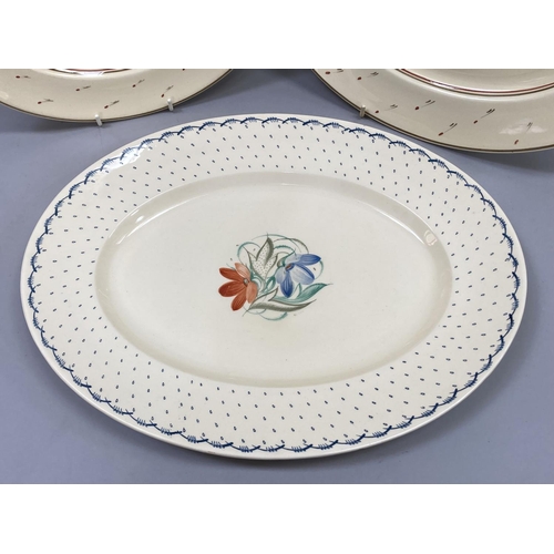 75 - A Susie Cooper cactus pattern meat plate within a blue dash border, together with a pair of graduate... 