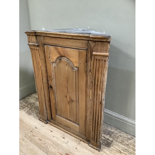 115 - A pine hanging corner cupboard, 19th century,  with colonnade supports, three internal shelves, no l... 