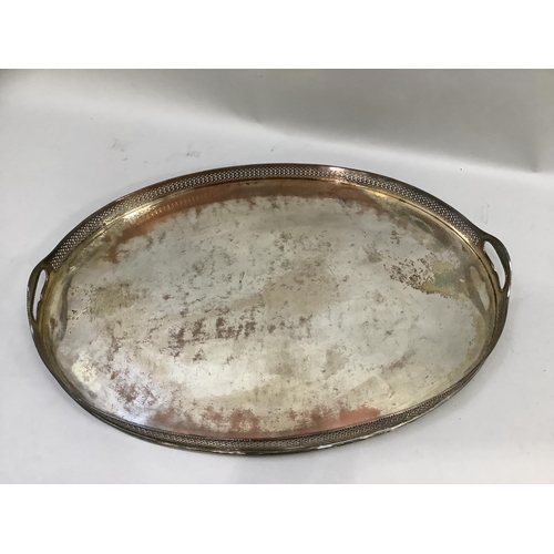 49 - A silver plated on copper two handled tray of oval outline with pierced gallery, 61cm by 44cm