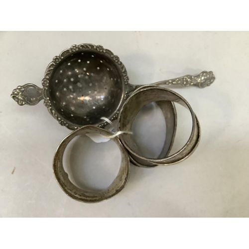 374 - Silver napkin rings all engraved (at fault) together with an EPNS tea strainer, total approximate we... 