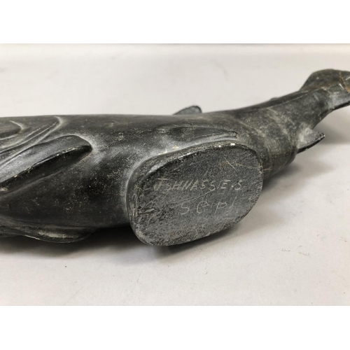 54 - An Inuit stone carving of a salmon signed to the underside Johnassie.S, damage and repair to the tai... 