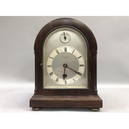 55 - An early 20th century mantel clock of domed outline, the silvered dial with Arabic Roman numerals, o... 