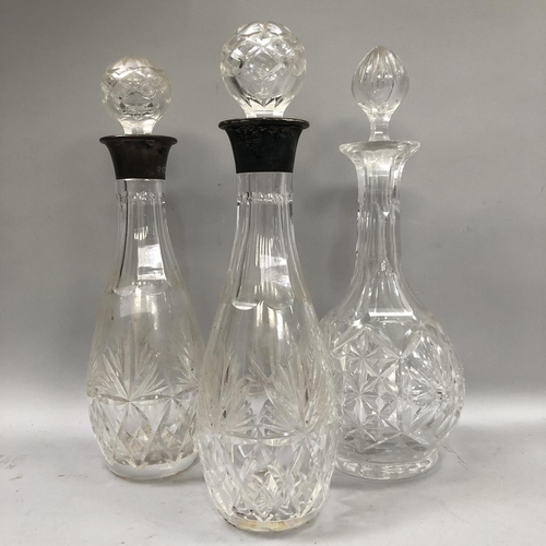 59 - A pair of silver collared cut glass decanters, Birmingham 1996 33.5cm high, together with a further ... 