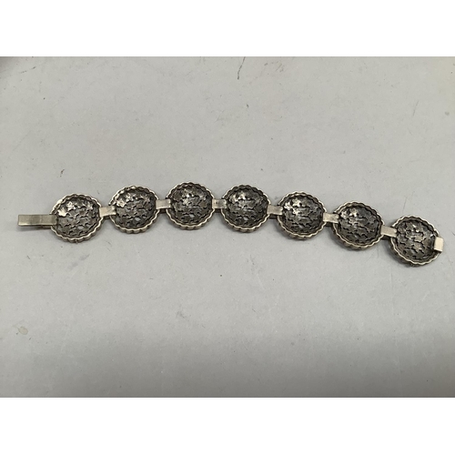 410 - A marcasite set silver bracelet each roundel link with pierced stars, approximate length 17.5cm, app... 