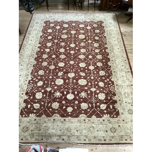 535 - A large Zeigler style burgundy and cream floral rug with deep cream border