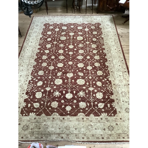 535 - A large Zeigler style burgundy and cream floral rug with deep cream border