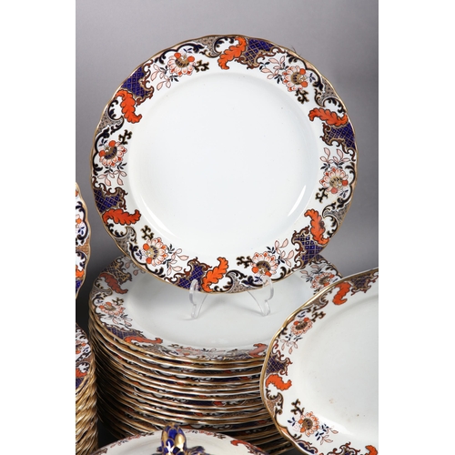 80 - A ROYAL DOULTON POTTERY DINNER SERVICE, of 'New Chantilly' pattern bordered in underglaze blue, iron... 