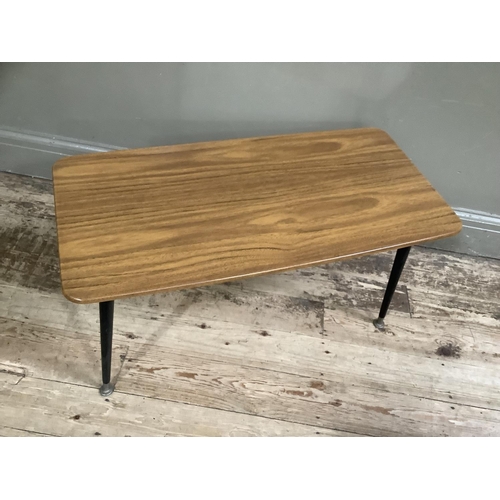 142 - A mid 20th century Formica coffee table on brass and black legs, 75cm wide, 36cm deep, 41cm high