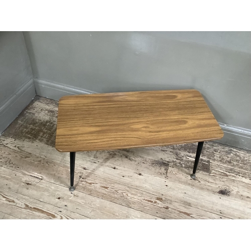 142 - A mid 20th century Formica coffee table on brass and black legs, 75cm wide, 36cm deep, 41cm high