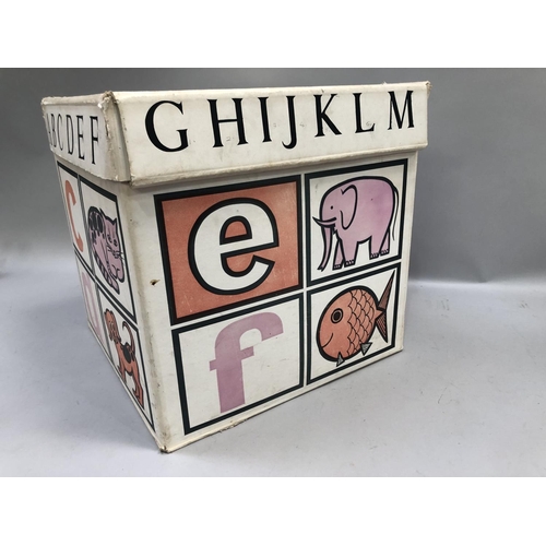 152B - A vintage toy box in white cardboard with alphabet and play toys in orange, pink and black