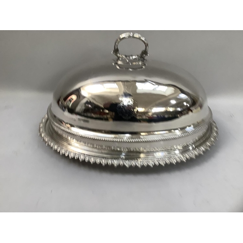 311 - A silver plated meat cover and associated stand, the cover having a reeded loop handle and gadroon r... 