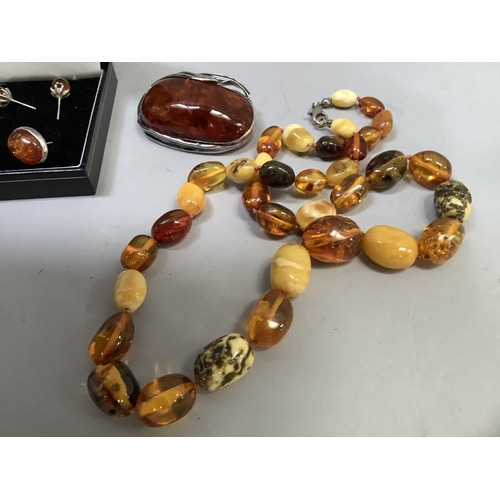 390 - A small collection of Baltic amber set jewellery in silver including an oval brooch, two pairs of st... 