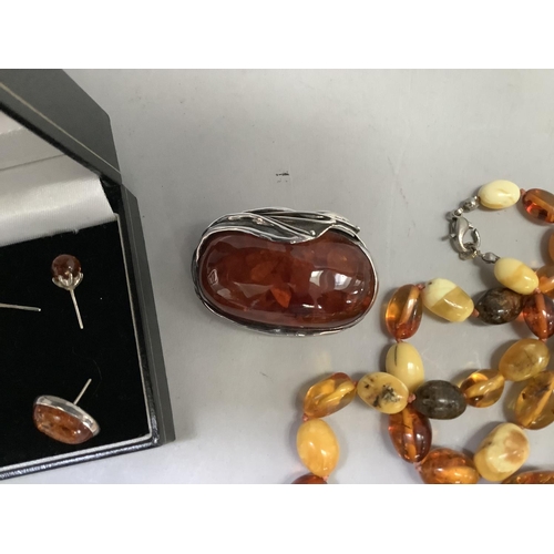 390 - A small collection of Baltic amber set jewellery in silver including an oval brooch, two pairs of st... 