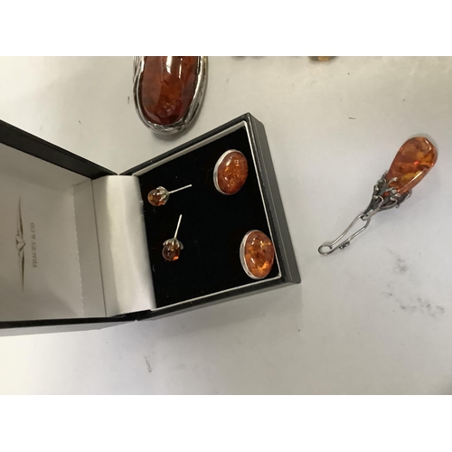 390 - A small collection of Baltic amber set jewellery in silver including an oval brooch, two pairs of st... 