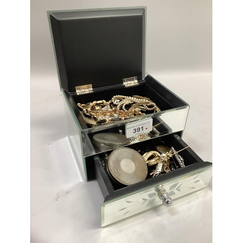 391 - A mirrored jewellery box containing necklaces, brooches etc by various makers, including Christian D... 