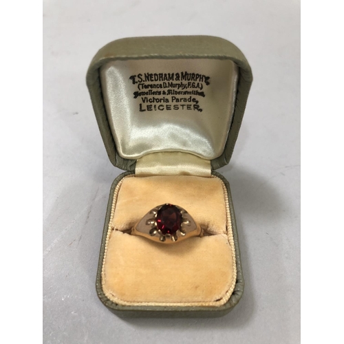 411B - A George V single stone garnet ring in 9ct rose gold, the oval facetted stone claw set, approximate ... 