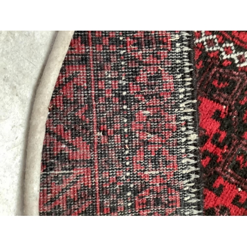 538 - Eastern red and black rug with central geometric pattern, 153cm x 87cm