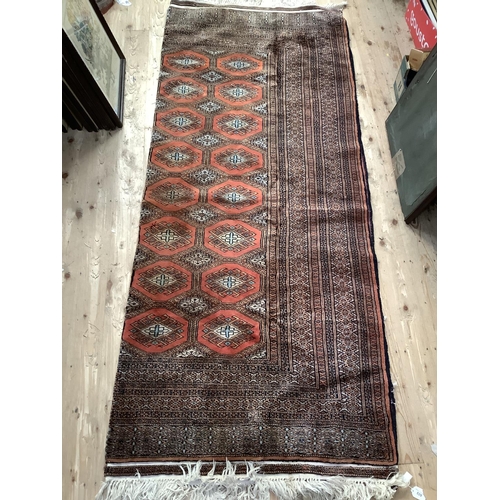 539 - A Middle eastern silk square floor rug with red diamonds within heavy mosaic border, 220cm x 180cm