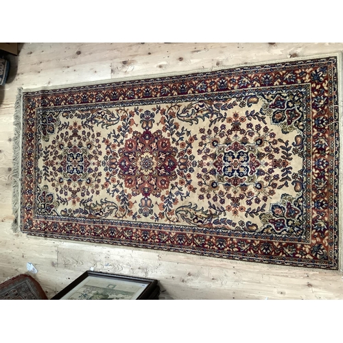 542 - A gold woven carpet with central panel of three large flowers on cream ground with scrolling leafage... 