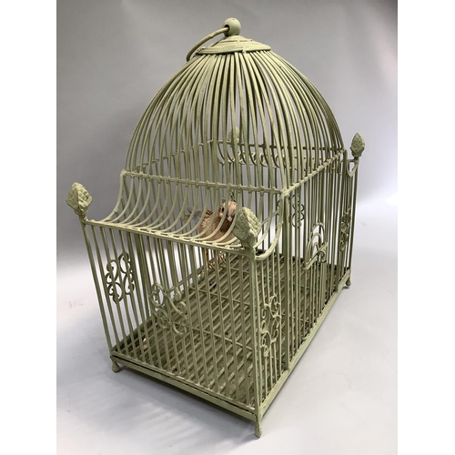 266 - A green wire ornate bird cage with four acorn finials, arched door and ring pull handle , including ... 