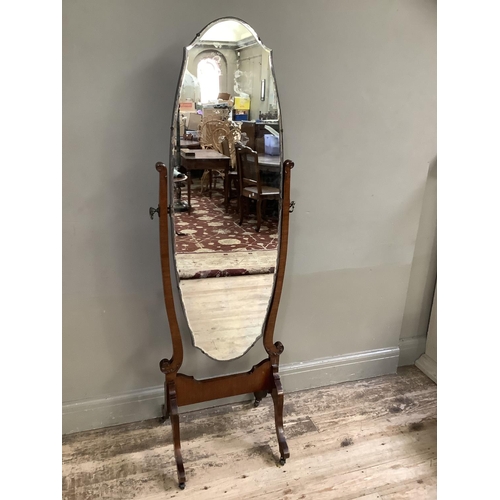 270 - A 1920s/30s cheval mirror with bevelled glass on twin supports