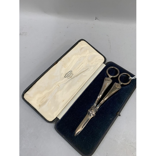 359 - An Edward VII pair of silver grape scissors with scallop handles, hallmarked Sheffield 1902 for Atki... 