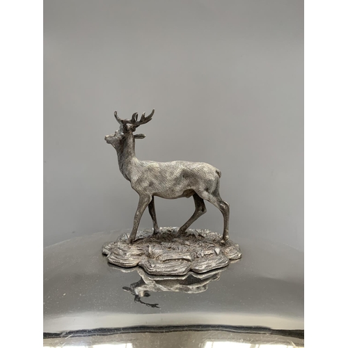 65 - A silver plated meat cover with stag finial, the domed body engraved with a crest depicting profile ... 