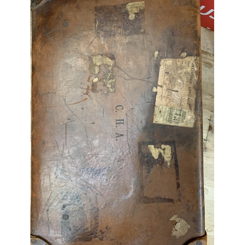 293 - A vintage leather suitcase initialled CHA, stamped to the front with Atlantic Transport to back toge... 