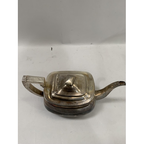 355B - A George III silver teapot of oval outline, with engraved border to the rim, lid and handle feet wit... 